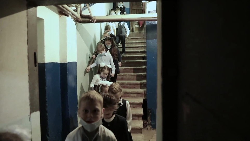 In images which brought back memories of the Blitz, the primary school pupils were led down in single file into an underground bomb shelter as they prepared for an assault from Vladimir Putin’s forces