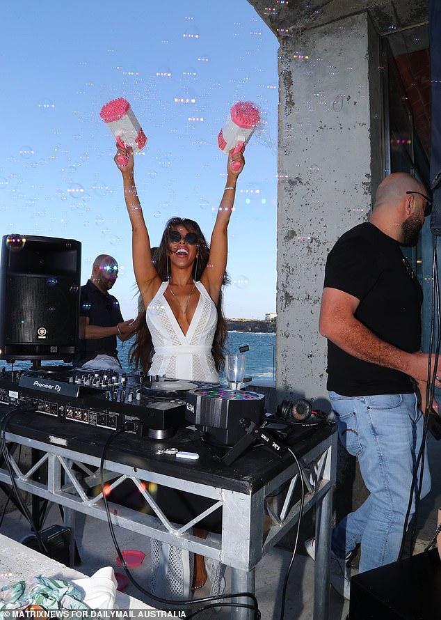 The glamorous DJ puts the pedal to the metal and blows soap bubbles in the air