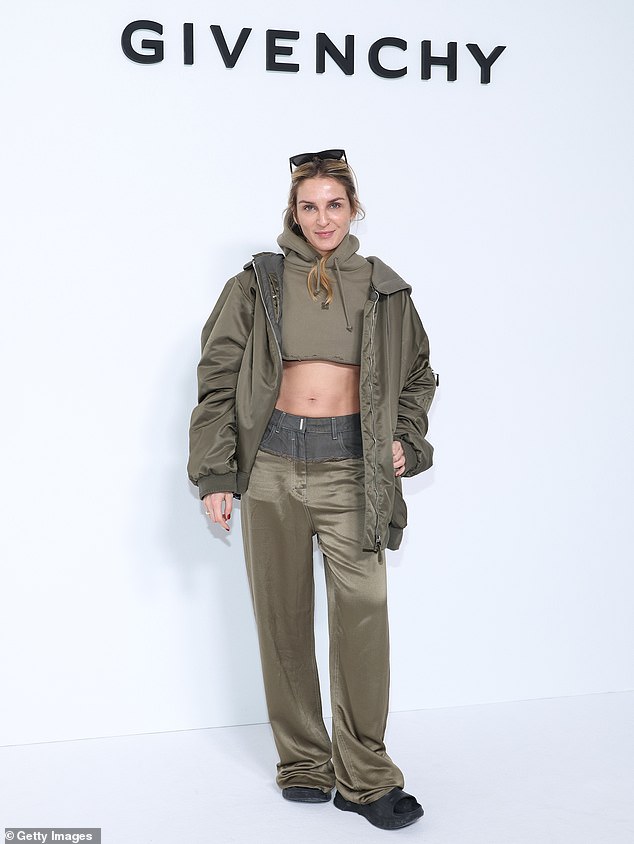 Chiseled: He posed alongside Gaia Repossi, who showed off her toned abs in a green cropped hoodie
