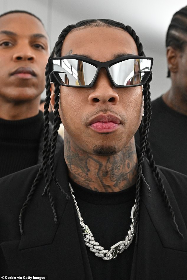 Trendy: The rapper hid his eyes behind futuristic-looking sunglasses while his dark hair was in neat braids