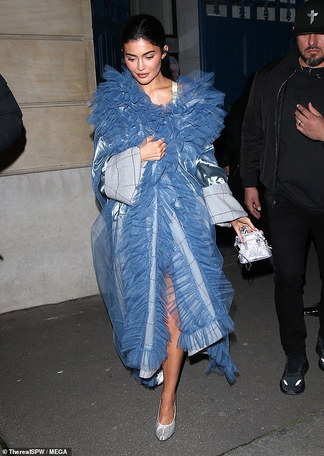 Princess Kylie: She later appeared in a striking baby blue coat and silver heels for the Maison Margiela Paris Fashion Week show, resembling a Cinderella look
