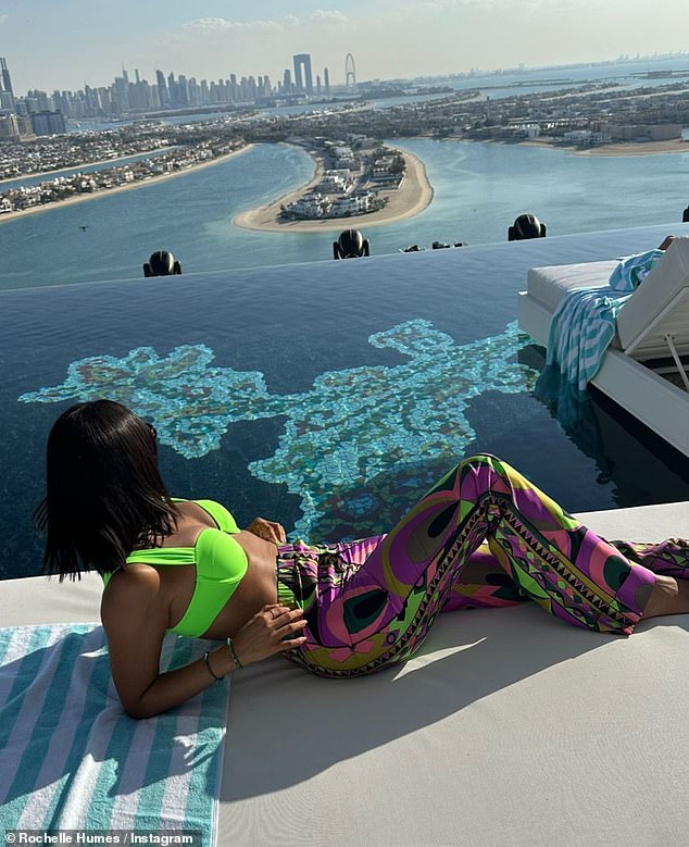 Hot stuff: The singer, 33, showed off her enviable physique in a neon green bikini top and chic, multicolored pants as she stretched out on a terrace
