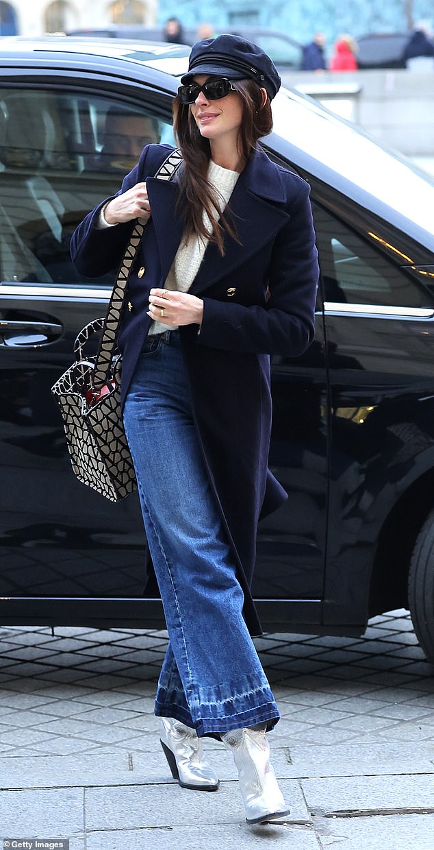 Stylish: She nailed Parisian chic in a Baker Boy hat and wide-leg jeans as she arrived in the French capital for the much-anticipated event