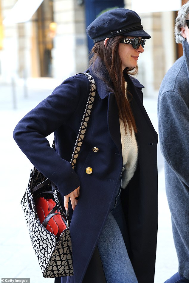 Effortlessly cool: Anne kept the chill off with a sophisticated off-white sweater and navy blue long wool coat over it