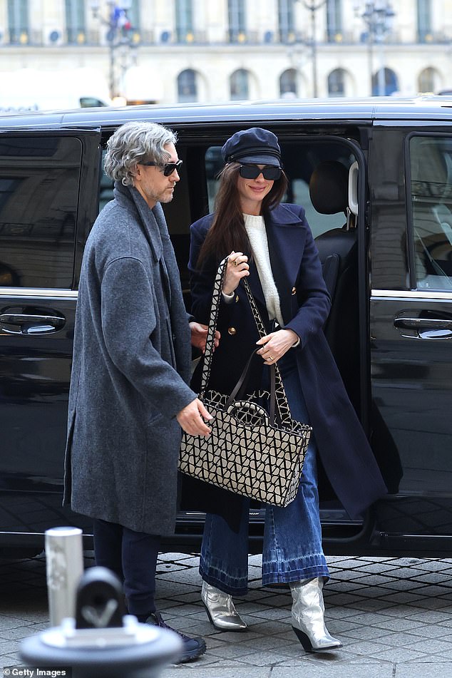 Striking: She upped her height with a quirky pair of metallic silver western-style boots and carried an oversized Valentino Garavani crossbody bag