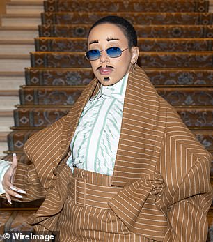 Whimsical: In the couture mood, the 27-year-old singer made another bold statement when she arrived with glued-on eyebrows, a mustache and goatee