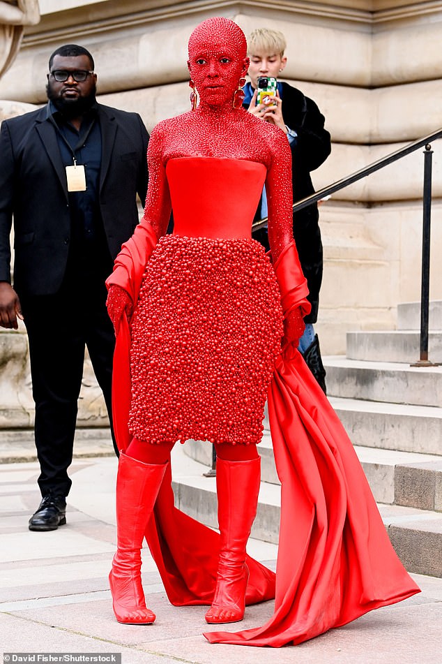 Striking: The singer attended the Schiaparelli show earlier this week in head-to-toe red body paint with 30,000 Swarovski crystals