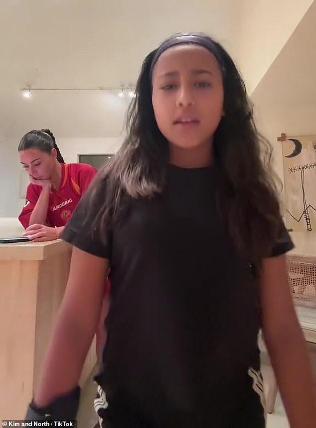 Cool and calm: Kim Kardashian appeared unperturbed by ex-Kanye West's latest headline-making incident as she appeared in a new TikTok clip with daughter North West on Friday night