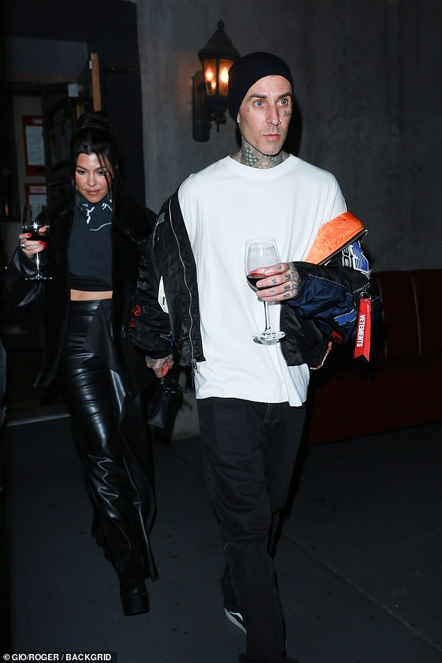 Cheers: Kourtney Kardashian and husband Travis Barker took their red wine with them on Wednesday after enjoying a dinner with Addison Rae in LA