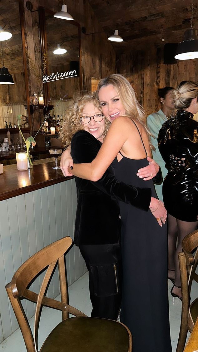 Thanks for coming: In a sweet moment, Amanda hugged Kelly as they posed for a fun photo next to the restaurant bar