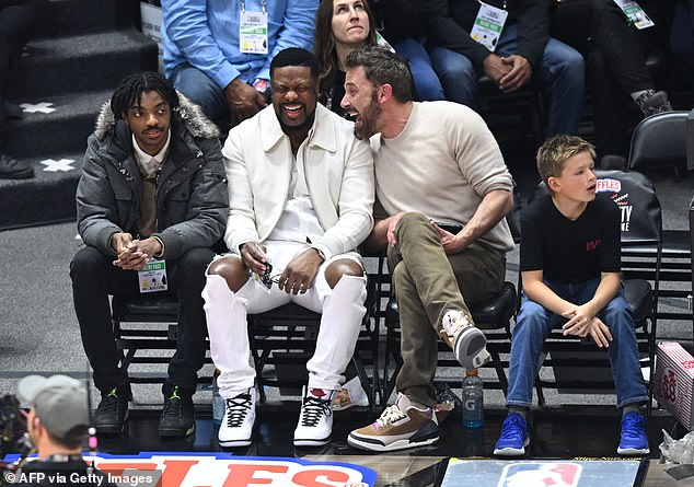 Courtside: The duo sat next to comedian Chris Tucker, who brooded over a joke Ben whispered in his ear mid-game