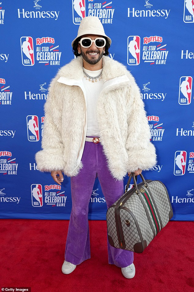 1970s Energy: Singh wore a white coat, bucket hat and bright purple pants when he arrived at the Celebrity Game