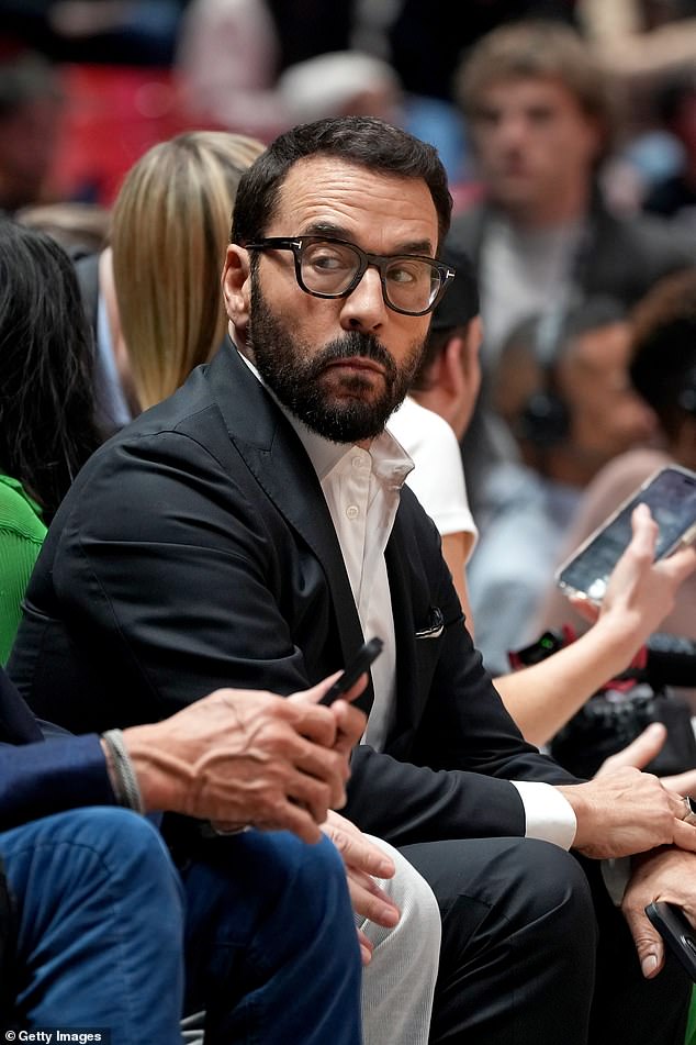 Watch the game: Actor Jeremy Piven sat on the sidelines and took in the action in a crisp black suit and white button-down shirt
