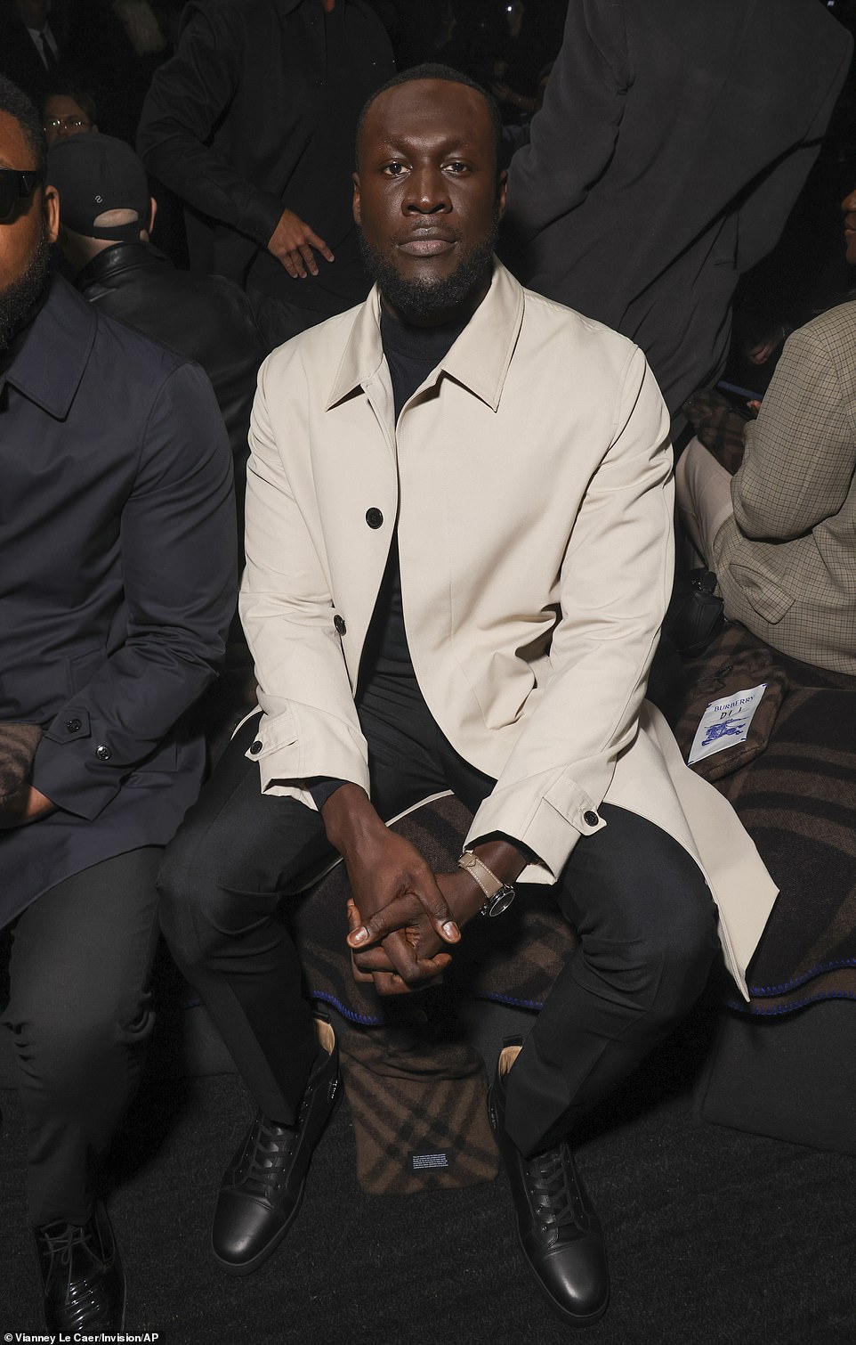 Handsome: Stormzy is dressed to impress in a cream Burberry coat teamed with a black top and matching trousers