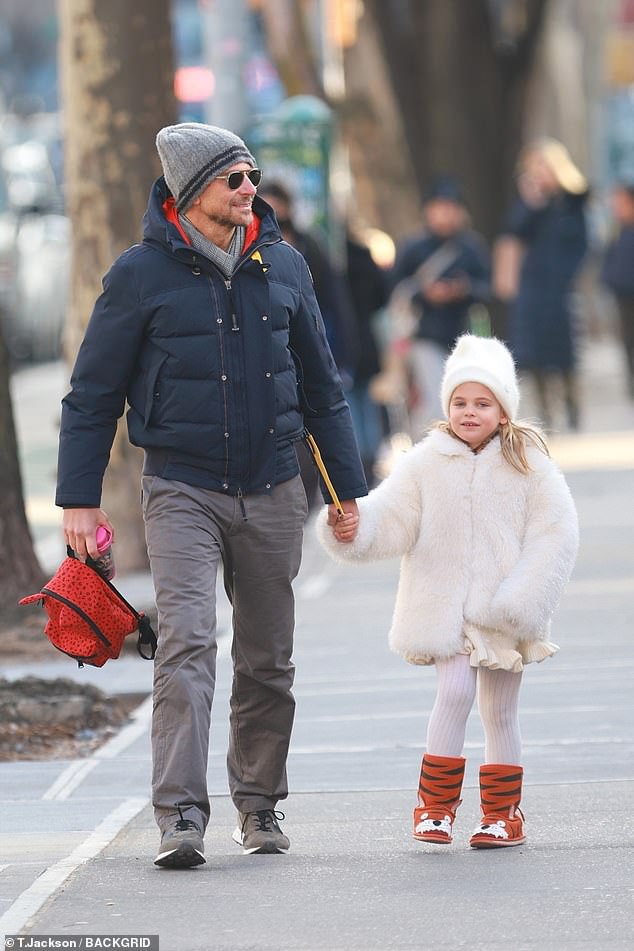 Doting dad: Bradley Cooper was one doting dad as he held hands with his adorable daughter Lea, five, during an outing in NYC on Thursday