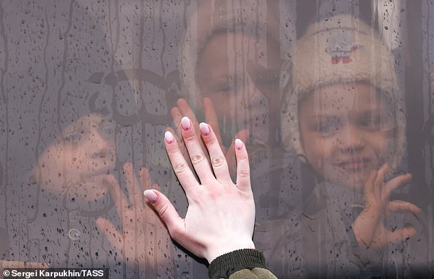 The ICC called for Putin's arrest as the court accused the despot of unlawfully kidnapping Ukrainian children from their homes and deporting them to Russia to hand them over to Russian families.  Pictured: Ukrainian children board a train from Ukraine's Donbass region to Russia on February 22, 2022