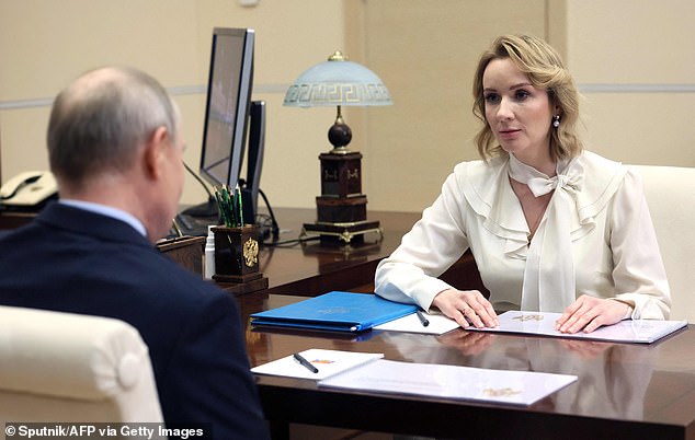 The ICC also issued an arrest warrant for Maria Alekseyevna Lvova-Belova (pictured with Putin in February), Russia's 