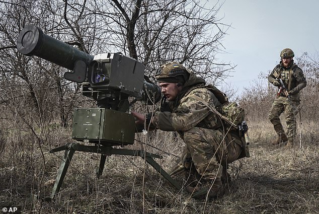 Ukrainian soldiers install a Stugna anti-tank missile system near Bakhmut in Ukraine's Donetsk region on Friday