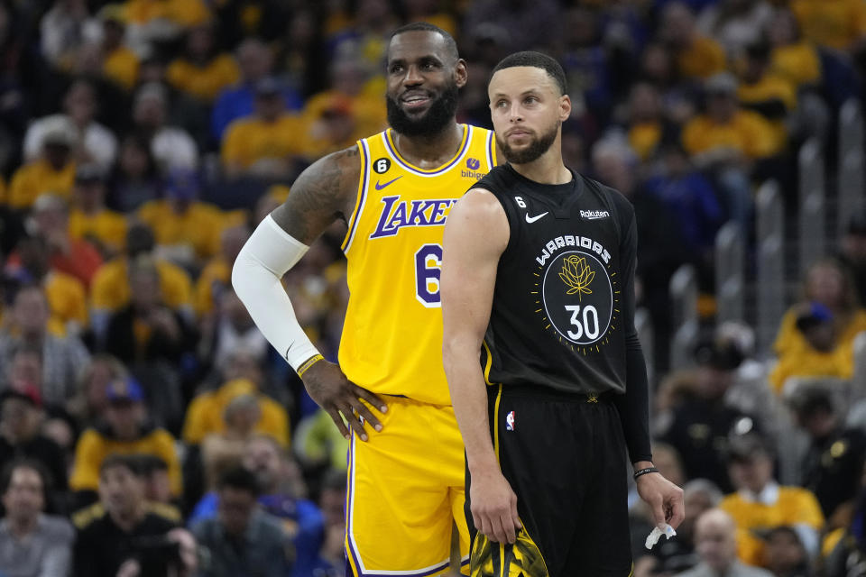Los Angeles Lakers forward LeBron James (6) and Golden State Warriors guard Stephen Curry (30) stand together in the first half of Game 1 of their Western Conference Semifinals series May 2, 2023 in San Francisco.  (AP Photo/Jeff Chiu)