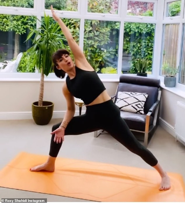 Keep fit: The star regular uses Instagram to share her yoga routines with her followers as she stretches out in her sunroom