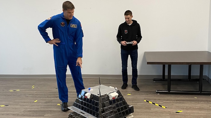 Jeremy Hansen and his son Devon pilot a Canadian lunar rover prototype.