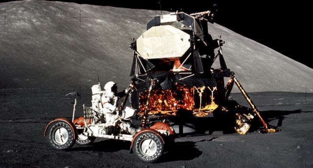 Apollo 17 commander Gene Cernan drives a lunar rover, with the lunar lander visible in the background.  Apollo 17 spent 75 hours on the lunar surface, the longest lunar stay of any manned mission.  Eugene Cernan, commander of the Apollo 17 mission, controls the lunar vehicle at the Taurus-Littrow landing site at the start of the mission's first moonwalk.  The lunar module can be seen in the background.